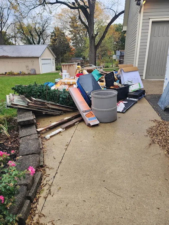 Dumpster being loaded with debris for Estate Cleanout Dumpster Rental in Becker